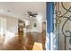 Open-concept living room and kitchen featuring hardwood floors, fresh white paint, and modern ceiling fan at 1541 Pontiac Se Pl, Atlanta, GA 30315