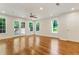 Spacious living room with hardwood floors, recessed lights, access to deck, and multiple windows at 1541 Pontiac Se Pl, Atlanta, GA 30315