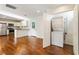 Open concept living room featuring gleaming hardwood floors and a stacked washer and dryer at 1541 Pontiac Se Pl, Atlanta, GA 30315