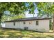 View of the back exterior of a brick home with a spacious yard and mature trees at 2905 Gresham Se Rd, Atlanta, GA 30316
