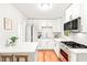 Bright kitchen features white cabinets, stainless steel appliances and wood floor at 2905 Gresham Se Rd, Atlanta, GA 30316