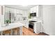 Bright kitchen features modern appliances, white cabinets, quartz countertops, and an eat-in breakfast bar at 2905 Gresham Se Rd, Atlanta, GA 30316