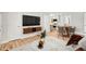 Cozy living room featuring white walls, wood floors, and views into a modern kitchen at 2905 Gresham Se Rd, Atlanta, GA 30316