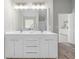 Bathroom featuring a double sink vanity, large mirror, and access to other rooms at 4087 Rosebud Park Dr, Snellville, GA 30039