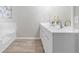 Stylish bathroom boasting dual sinks, a large mirror, and a soaking tub at 4087 Rosebud Park Dr, Snellville, GA 30039
