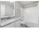 Bright bathroom with a granite countertop vanity, toilet, and shower-tub combination at 4087 Rosebud Park Dr, Snellville, GA 30039