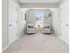 Cozy bonus room area with two chairs, artwork, and neutral carpet at 4087 Rosebud Park Dr, Snellville, GA 30039