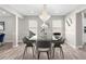 Elegant dining room with modern chandelier, hardwood floors, and an open floor plan at 4087 Rosebud Park Dr, Snellville, GA 30039