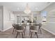 Bright dining room featuring modern chandelier, glass table, and gray walls at 4087 Rosebud Park Dr, Snellville, GA 30039