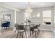 Elegant dining room with modern chandelier, hardwood floors, and an open floor plan at 4087 Rosebud Park Dr, Snellville, GA 30039