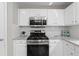 Kitchen with white cabinets, stainless steel appliances, and granite countertops at 4087 Rosebud Park Dr, Snellville, GA 30039