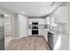 Well-lit kitchen featuring white cabinets, stainless steel appliances, and granite countertops at 4087 Rosebud Park Dr, Snellville, GA 30039