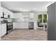Bright kitchen with white cabinets, stainless steel appliances, and granite countertops at 4087 Rosebud Park Dr, Snellville, GA 30039