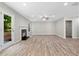 Open living room features wood floors, a modern fireplace, and abundant natural light at 4087 Rosebud Park Dr, Snellville, GA 30039