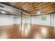 Large basement with wood flooring, painted walls, and exposed ceiling structure at 4316 Acuba Sw Ct, Lilburn, GA 30047