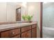 Bathroom featuring a wood vanity, countertop, and a mirror, offering a functional and stylish space at 4316 Acuba Sw Ct, Lilburn, GA 30047
