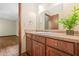 Bathroom featuring a wood vanity, countertop, and a mirror, offering a functional and stylish space at 4316 Acuba Sw Ct, Lilburn, GA 30047