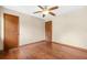 Simple bedroom with wood floors, ceiling fan, and natural light, offering a comfortable living space at 4316 Acuba Sw Ct, Lilburn, GA 30047