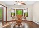 Cozy breakfast nook featuring a round table, wood floors, and a bay window with a view of lush greenery at 4316 Acuba Sw Ct, Lilburn, GA 30047