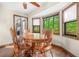 Charming dining area with hardwood floors, a round wooden table, and a bay window providing natural light at 4316 Acuba Sw Ct, Lilburn, GA 30047