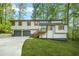 Charming home with a two-car garage, landscaped yard, and a delightful porch entrance at 4316 Acuba Sw Ct, Lilburn, GA 30047
