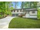Charming home with a two-car garage, landscaped yard, and a delightful porch entrance at 4316 Acuba Sw Ct, Lilburn, GA 30047