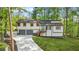 Charming home with a two-car garage, landscaped yard, and a delightful porch entrance at 4316 Acuba Sw Ct, Lilburn, GA 30047