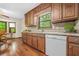 Kitchen features wood cabinets, tile countertops and a large bay window above the sink at 4316 Acuba Sw Ct, Lilburn, GA 30047