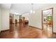 Open-concept living room with hardwood floors, and seamless flow to dining area at 4316 Acuba Sw Ct, Lilburn, GA 30047