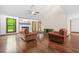 Inviting living room boasts a fireplace, wood floors and door to the backyard at 4316 Acuba Sw Ct, Lilburn, GA 30047