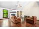 Cozy living room featuring wood floors, fireplace and large window with outdoor views at 4316 Acuba Sw Ct, Lilburn, GA 30047