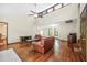 Bright living room features vaulted ceiling and wood floors at 4316 Acuba Sw Ct, Lilburn, GA 30047