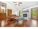 Bright living room features vaulted ceilings, wood floors, and a cozy fireplace at 4316 Acuba Sw Ct, Lilburn, GA 30047