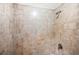 Close-up of a tiled shower with a shower head, showcasing a clean and functional bathroom feature at 4316 Acuba Sw Ct, Lilburn, GA 30047