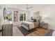 Light-filled bedroom with a tufted headboard, decorative art, and hardwood floors at 1237 Memorial Se Dr # 406, Atlanta, GA 30316