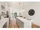 Open-concept kitchen featuring stainless steel appliances, island with seating, and a view to the living area at 1237 Memorial Se Dr # 406, Atlanta, GA 30316