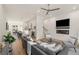 Open-concept living room featuring a gray sofa, ceiling fan, fireplace and hardwood floors at 1237 Memorial Se Dr # 406, Atlanta, GA 30316