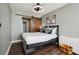 Comfortable bedroom with hardwood floors, a modern bed frame, and a stylish sliding barn door at 215 Piedmont # 1804, Atlanta, GA 30308