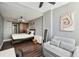 Comfortable bedroom featuring a sliding barn door, a cozy sofa and natural light at 215 Piedmont # 1804, Atlanta, GA 30308
