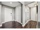 Well-lit hallway with dark hardwood floors, built-in storage closets, and neutral wall colors at 215 Piedmont # 1804, Atlanta, GA 30308