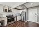 Modern kitchen with stainless steel appliances, granite countertops, white cabinets, and open layout at 215 Piedmont # 1804, Atlanta, GA 30308