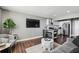 Comfortable living room with stylish furniture, a large television, and an open-concept kitchen at 215 Piedmont # 1804, Atlanta, GA 30308