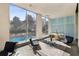 Sunny lobby space with seating overlooking the complex pool through large glass windows at 215 Piedmont # 1804, Atlanta, GA 30308