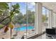 Scenic view of a sparkling pool surrounded by lush greenery, as seen through large windows at 215 Piedmont # 1804, Atlanta, GA 30308