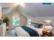 Staged bedroom featuring a comfortable bed with blue pillows, a window, and a cozy rug at 2240 E Lake Ne Dr, Conyers, GA 30012