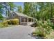 Charming gray home with a welcoming white porch and lush landscaping in a serene setting at 2240 E Lake Ne Dr, Conyers, GA 30012