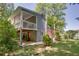 Exterior view of home with a spacious deck, lower-level access, and peaceful surroundings at 2240 E Lake Ne Dr, Conyers, GA 30012
