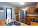 Cozy kitchen featuring stainless steel refrigerator, wooden cabinets, and a wood countertop with a stainless sink at 2240 E Lake Ne Dr, Conyers, GA 30012