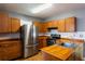 Well-equipped kitchen featuring wooden cabinets, stainless steel refrigerator and functional layout at 2240 E Lake Ne Dr, Conyers, GA 30012