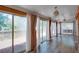 A bright sunroom with large sliding glass doors, curtains, hardwood floors, and beaded chandeliers at 2240 E Lake Ne Dr, Conyers, GA 30012